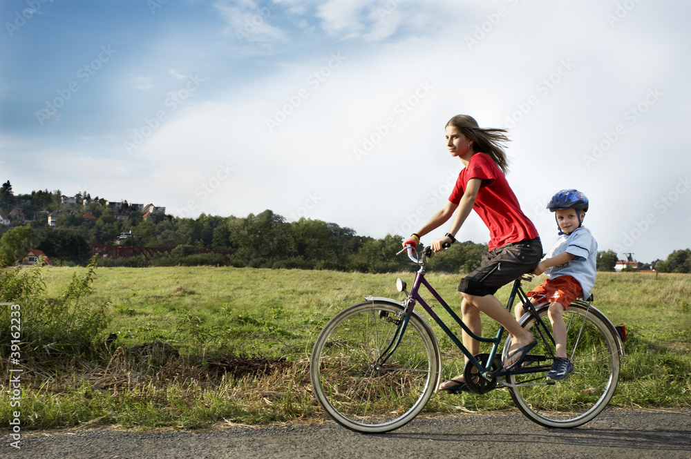Brother and sister riding a bike