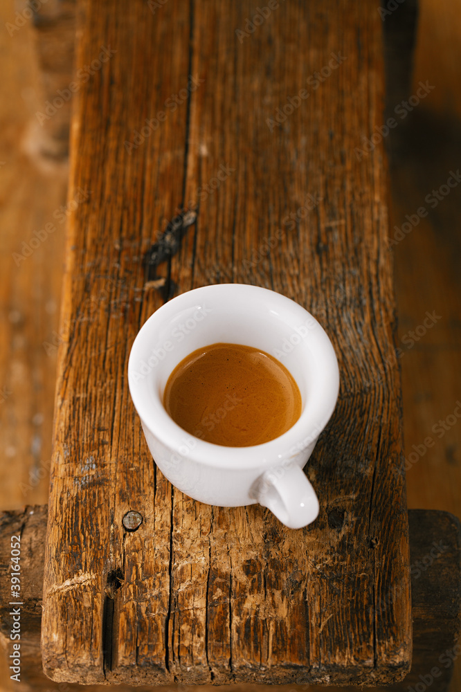 Obraz premium espresso coffee in thick white cup on old wooden bench