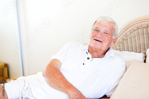 happy senior man lying on bed
