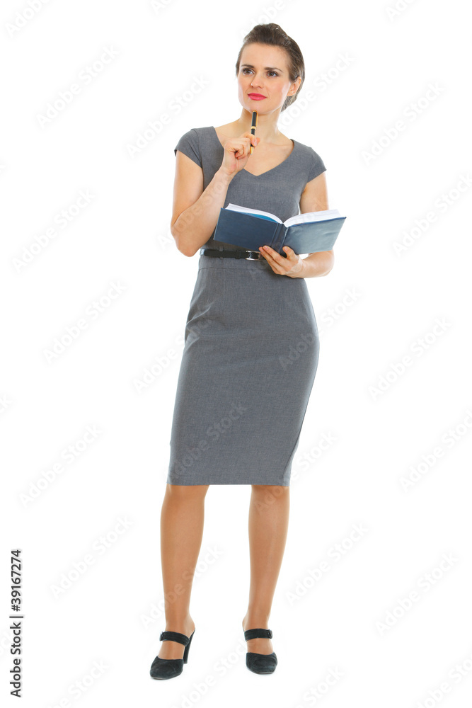 Full length portrait of female employee with notebook and pen Full length portrait of female employee with notebook and pen
