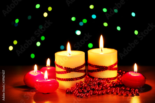 Beautiful candles and decor on wooden table on bright background