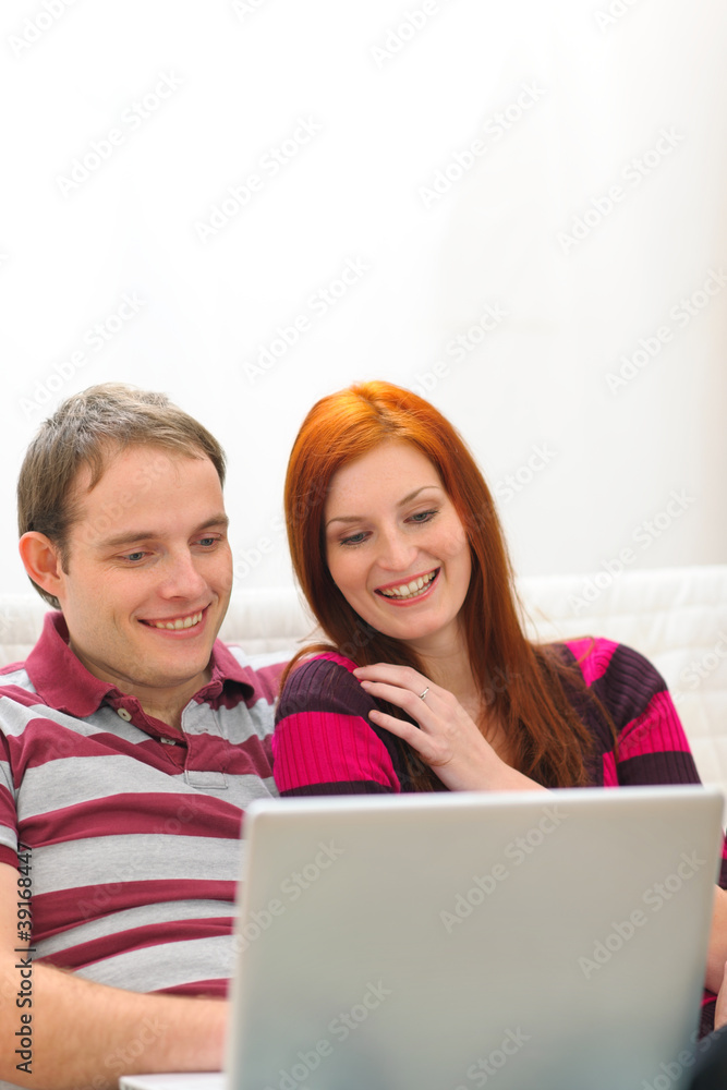 Happy young couple having fun time with laptop Happy young couple having fun time with laptop