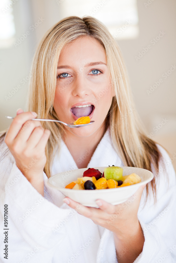 pretty young european woman eating fruit salad pretty young european woman eating fruit salad