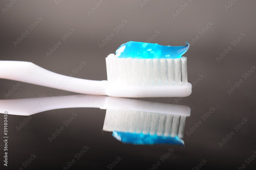 toothbrush with blue toothpaste on it toothbrush with blue toothpaste on it