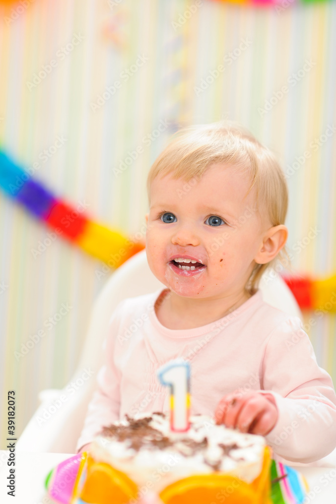 Portrait of eat smeared baby with birthday cake Portrait of eat smeared baby with birthday cake