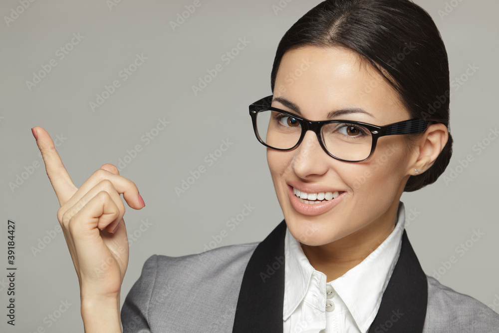 Closeup of young business woman pointing at copy space Closeup of young business woman pointing at copy space