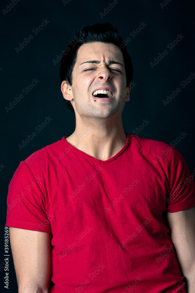 Man portrait with desperate expression on dark background. Man portrait with desperate expression on dark background.