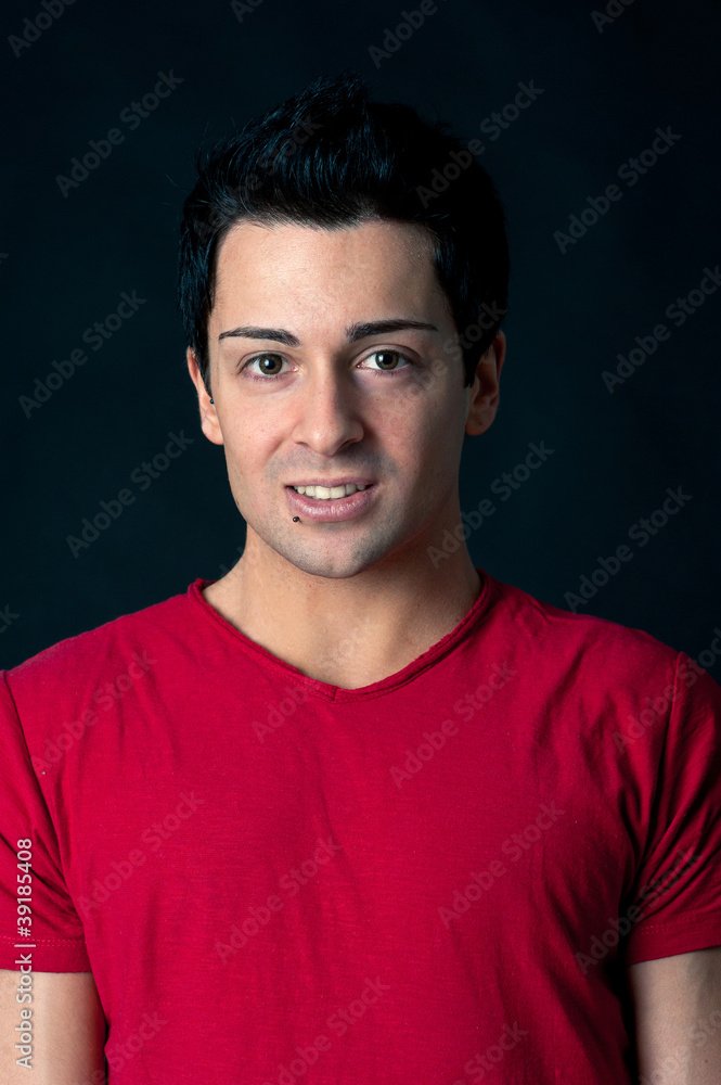 Man portrait with happy expression on dark background.