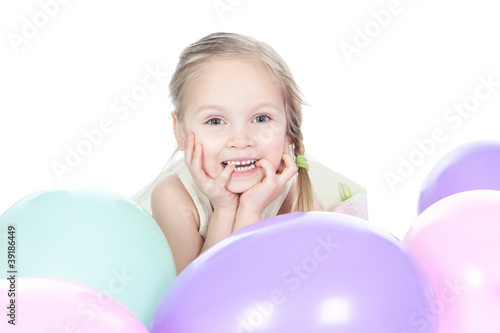 Little blonde girl with balloons in studio