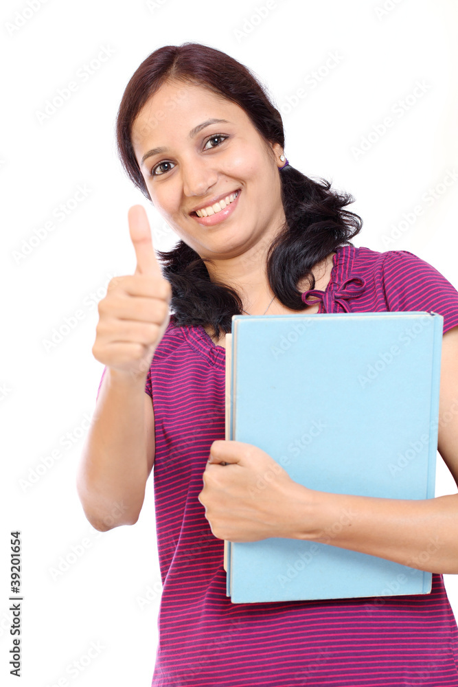 Indian student with her books and showing thumb-up gesture Indian student with her books and showing thumb-up gesture