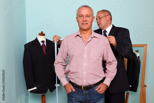 Man being fitted for a bespoke suit photo