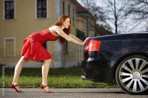 Young woman pushing the car © linkova