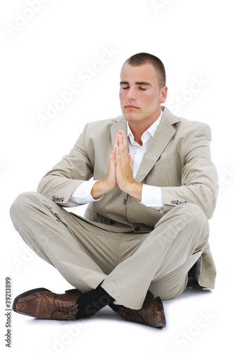 Young man meditating in office isolated on white photo