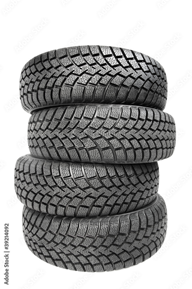 Stack of four car wheel winter tires isolated Stack of four car wheel winter tires isolated