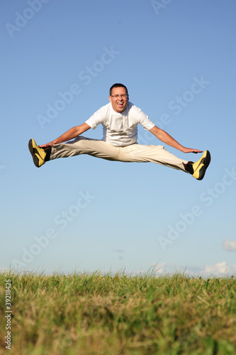 man jumping on green field