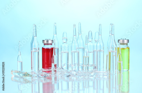 Medical ampoules on blue background