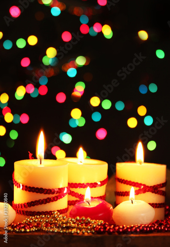 Beautiful candles and decor on wooden table on bright background