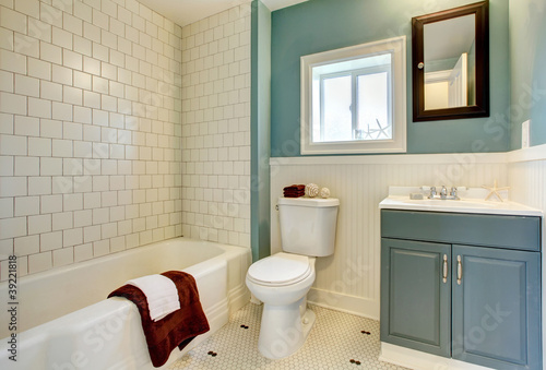 New remodeled blue bathroom with classic white tile.