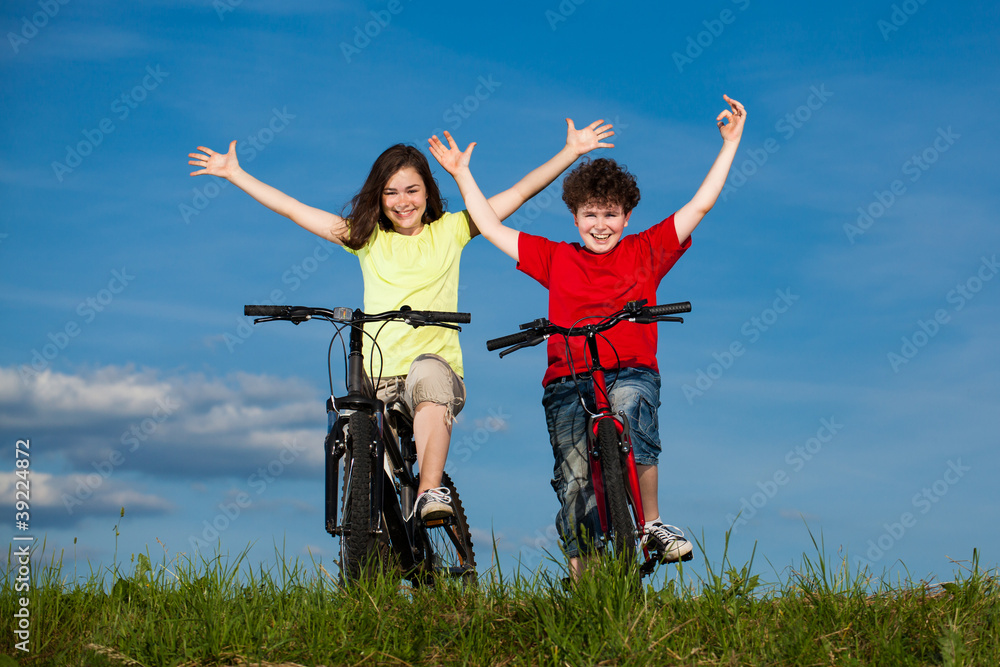 Girl and boy riding bikes Girl and boy riding bikes