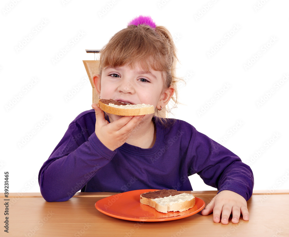 hungry little girl eats bread with chocolate cream hungry little girl eats bread with chocolate cream