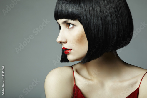 Fashion portrait of a young beautiful dark-haired woman