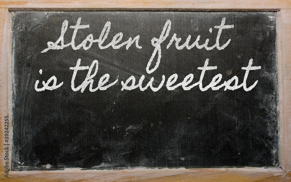 Fototapeta premium expression - Stolen fruit is the sweetest - written on a school