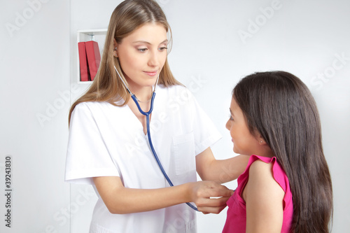 Doctor Examining Child in Clinic