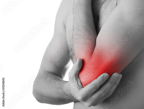 Photography Rear view of a young man holding his elbow in pain, isolated on