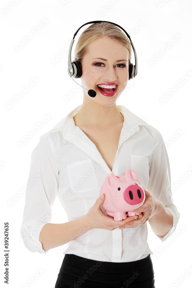 Young businesswoman with headset holding piggy bank Young businesswoman with headset holding piggy bank