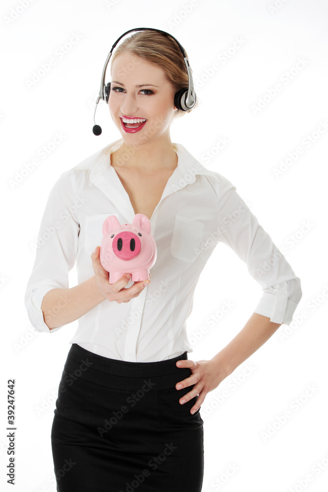 Young businesswoman with headset holding piggy bank Young businesswoman with headset holding piggy bank