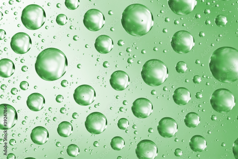 Water drops on green glass surface