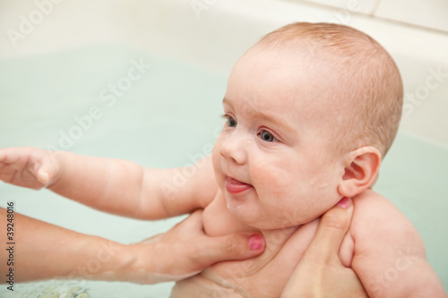 Baby swimming on mother's hands