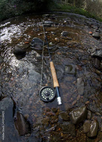 fly rod on a river bank