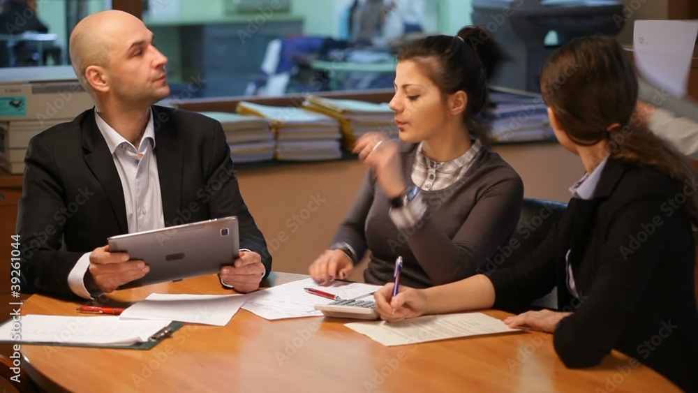 Team work in the office with tablet, giving documents Team work in the office with tablet, giving documents