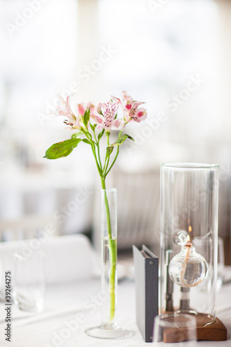 Lilly flower in a vase on a covered table