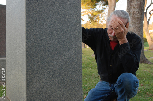 Man sitting at gravesite
