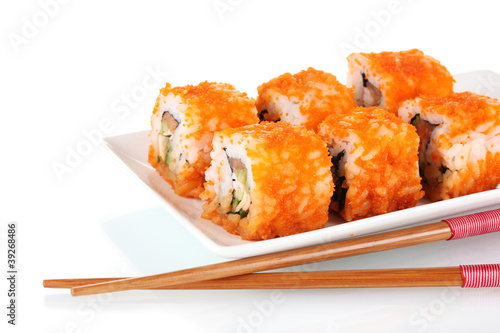 delicious sushi on plate and chopsticks isolated on white