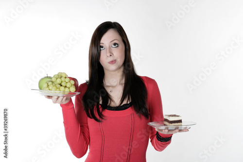 A pretty girl with fruit and cake on her hand