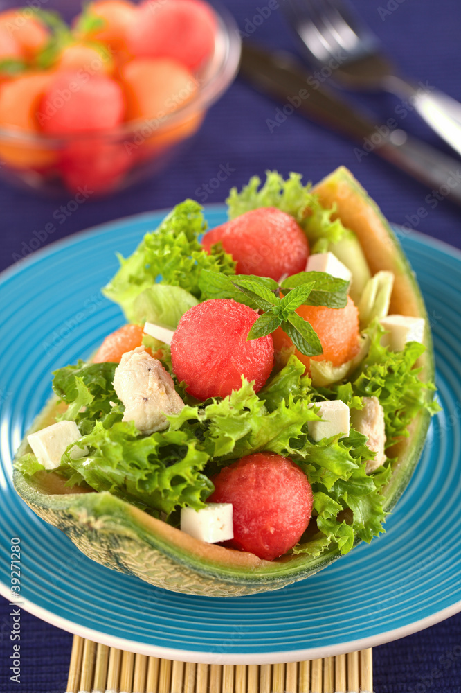 Salad made of melon, chicken, cucumber, cheese and lettuce Salad made of melon, chicken, cucumber, cheese and lettuce