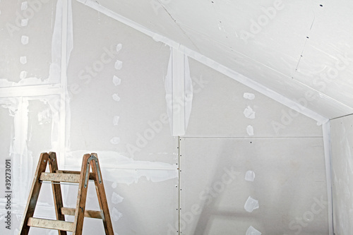 studwork: filling the joints of the plaster boards photo