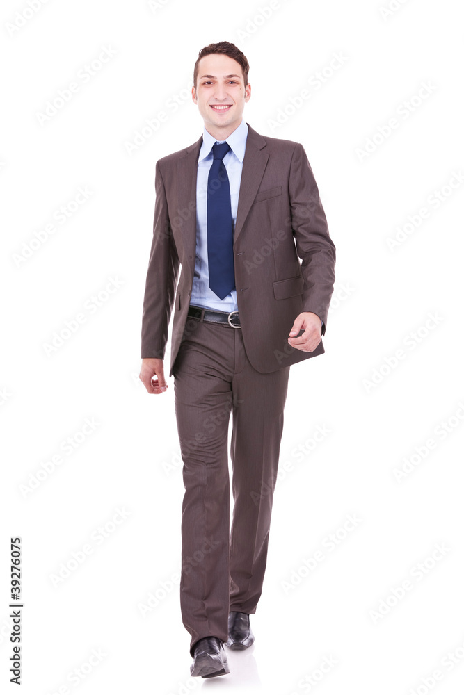 young business man is walking towards the camera young business man is walking towards the camera