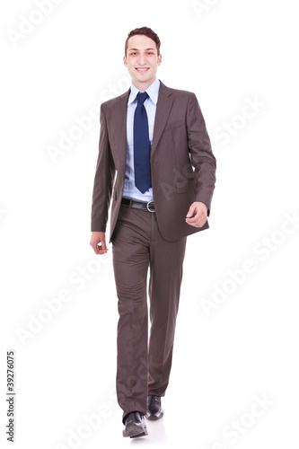 young business man is walking towards the camera