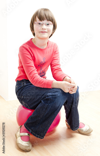 girl sitting on a ball