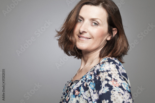 Happy middle age woman posing in studio.