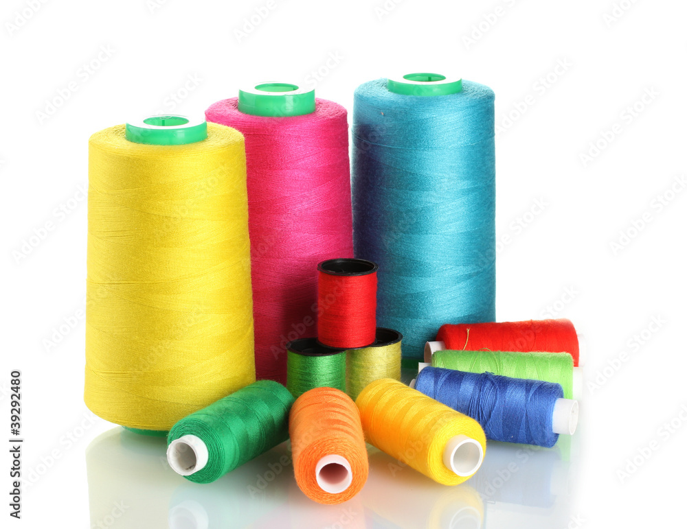Many-coloured bobbins of thread isolated on white Many-coloured bobbins of thread isolated on white