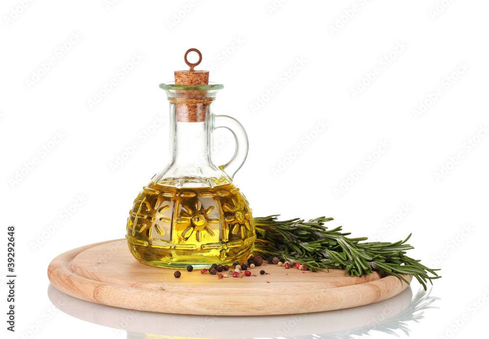 Oil in a bottle and fresh rosemaryon wooden board isolated Oil in a bottle and fresh rosemaryon wooden board isolated