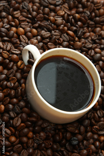 a cup on coffee beans