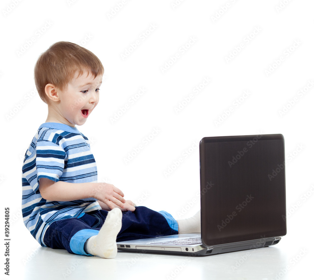 Funny child using a laptop over white background Funny child using a laptop over white background