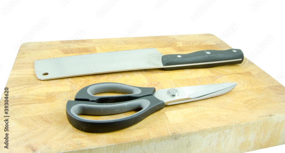 cleaver and scissors on wooden board cleaver and scissors on wooden board