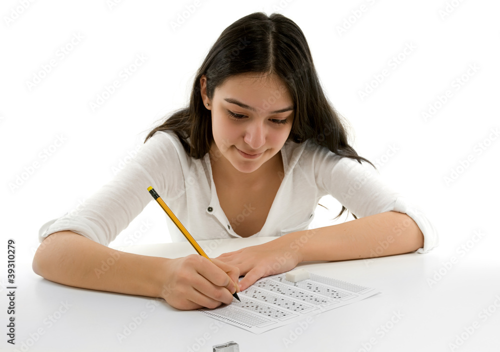 Student filling out answers to a test with a pencil Student filling out answers to a test with a pencil